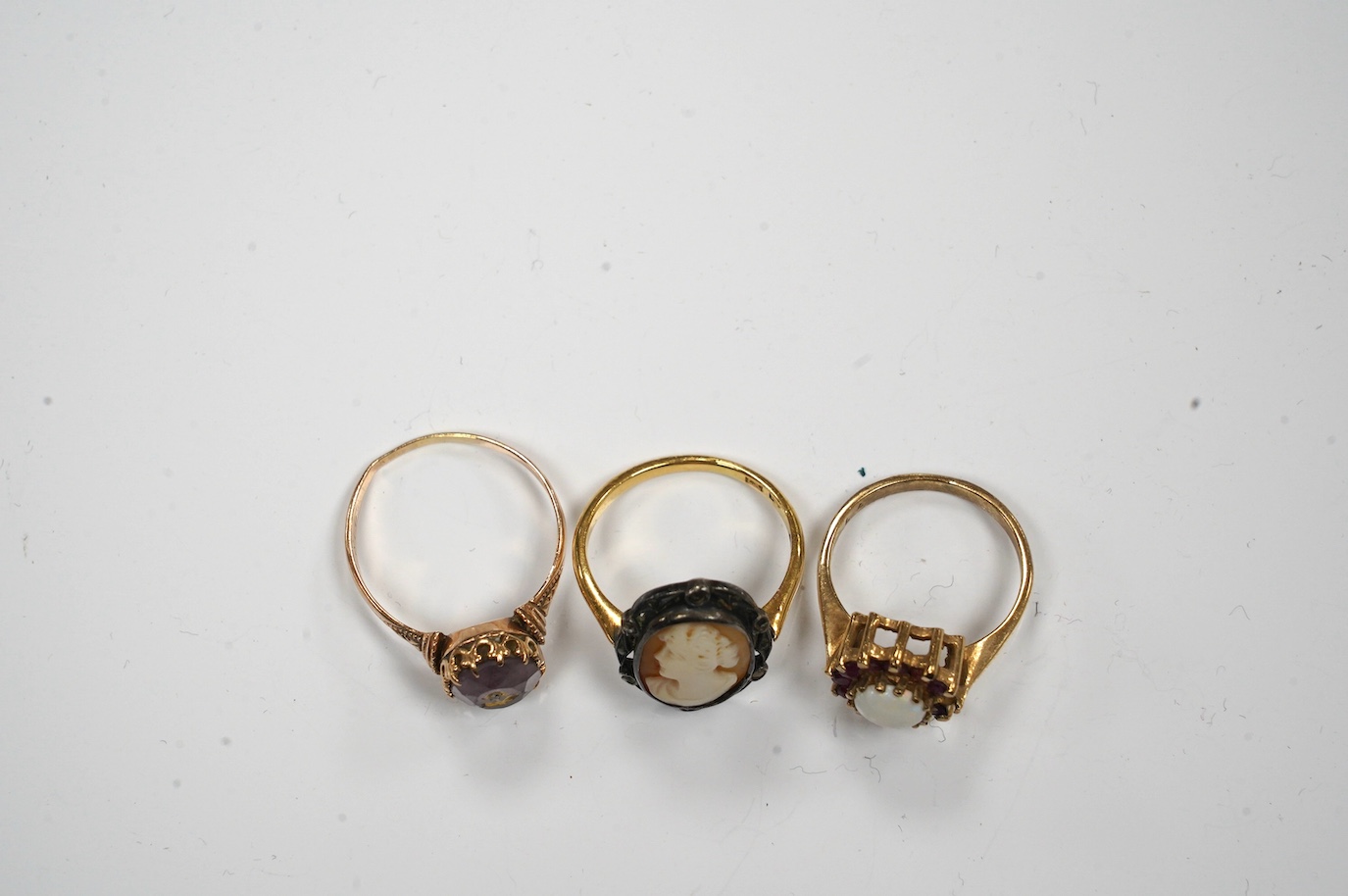 A late Victorian yellow metal amethyst and diamond chip set 'flower' ring, size P and two other rings. Condition - poor to fair